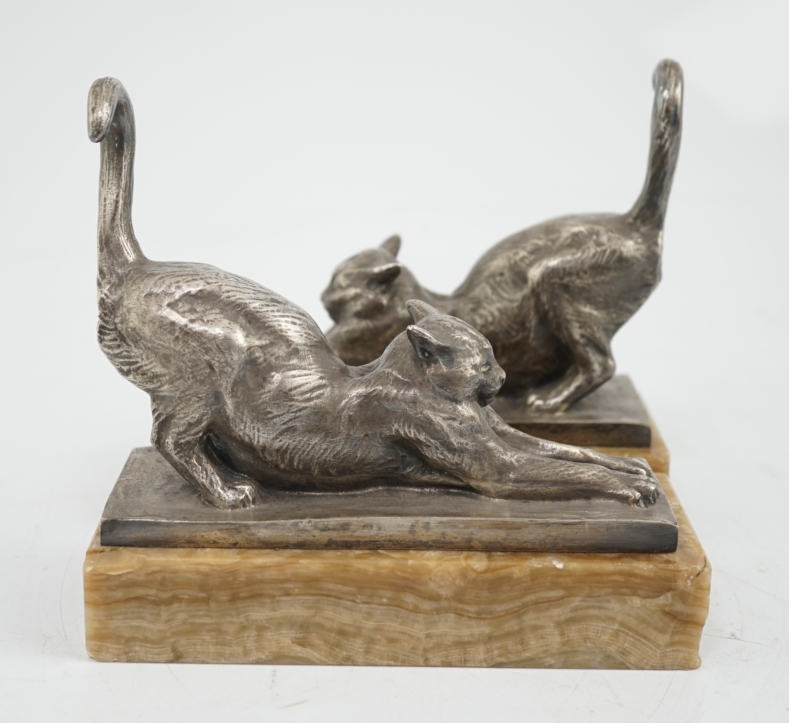 Louis Riché (French, 1877-1949), a pair of silvered bronze bookends modelled as stretching cats